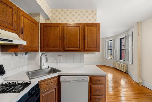 a kitchen with a sink stove and cabinets