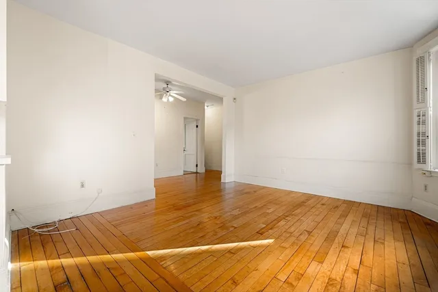 a view of a room with wooden floor