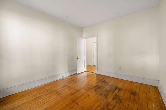 a view of an empty room and wooden floor