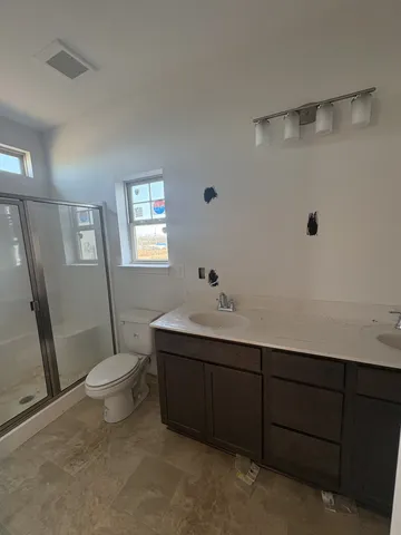 a white toilet sitting next to a bathroom sink