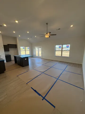 a kitchen with stainless steel appliances a refrigerator and a wooden floor