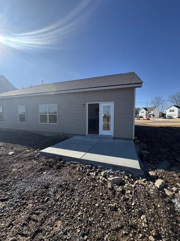 a view of a room with a ceiling fan and wooden floor
