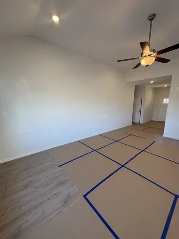 a view of a room with wooden floor