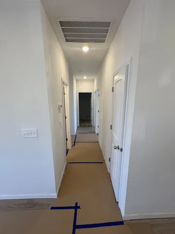 a view of a storage & utility room with refrigerator