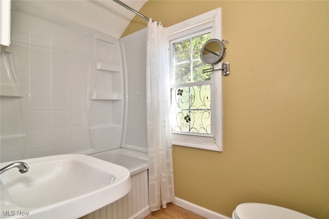 3679 Fenley Road Cleveland Heights, OH 44121 - Photo 28 of 45 Bathroom with vaulted ceiling, light wood finished floors, and shower / bath combo with shower curtain