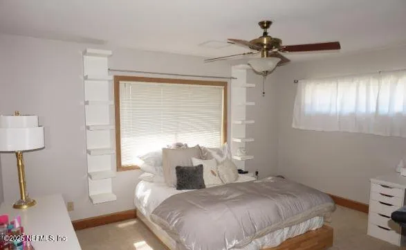 a bedroom with a bed and a desk