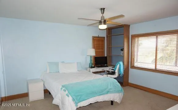 a bathroom with a granite countertop sink toilet and mirror
