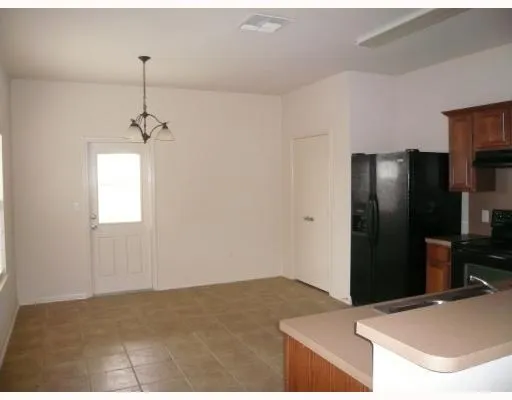 a kitchen with a refrigerator and a sink
