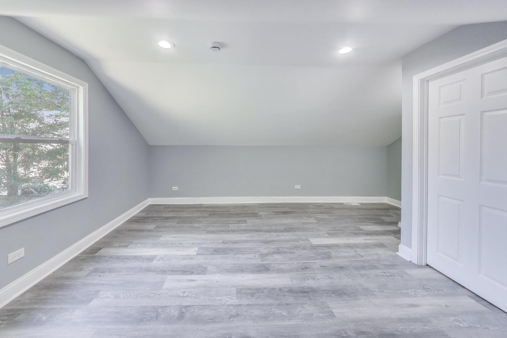Undisclosed Address Chicago, IL 60622 - Photo 23 of 33 a view of empty room with window and wooden floor