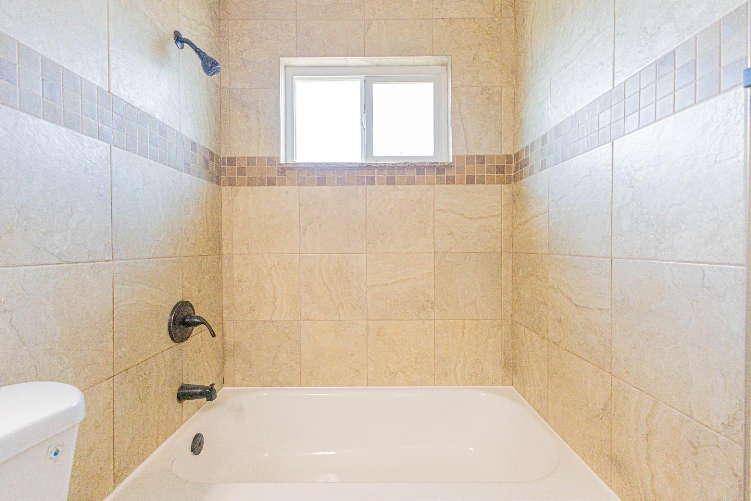 300 Walnut Street Madera, CA 93637 - Photo 11 of 12 a bathroom with a bathtub and a toilet