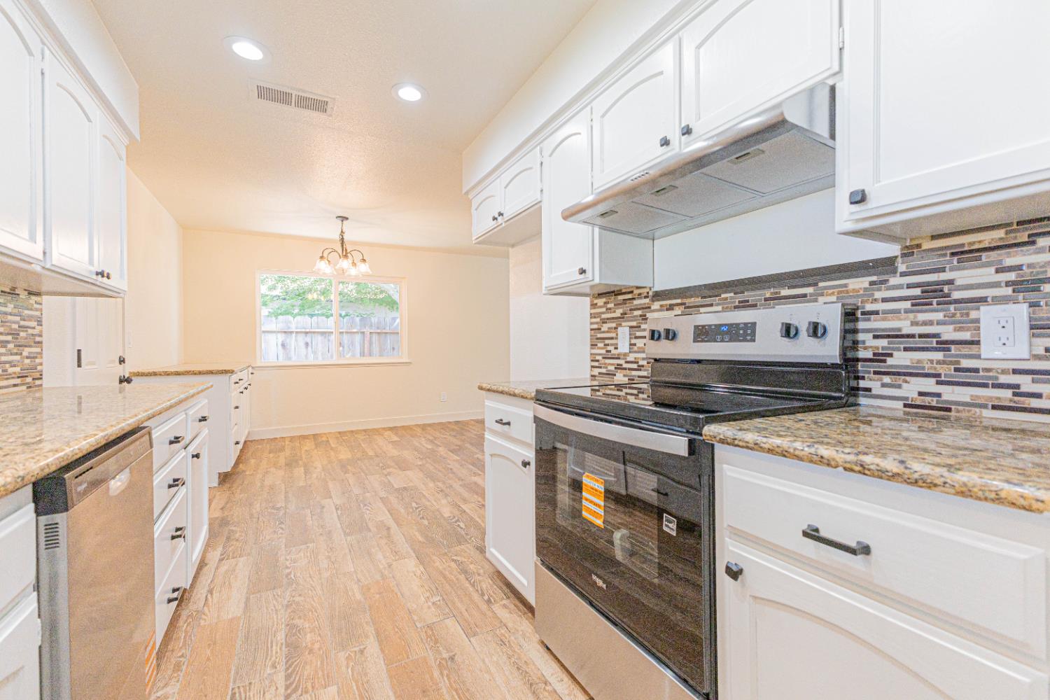 300 Walnut Street Madera, CA 93637 - Photo 7 of 12 a kitchen with a stove oven and sink
