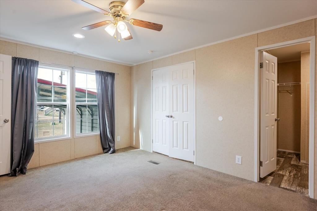 126 Starry Sky Court Springtown, TX 76082 - Photo 11 of 34 Bedroom featuring crown molding, carpet, and ceiling fan