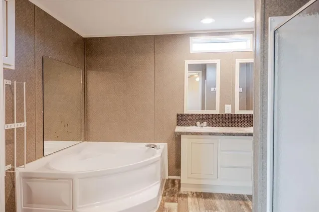 a bathroom with a bathtub and a sink