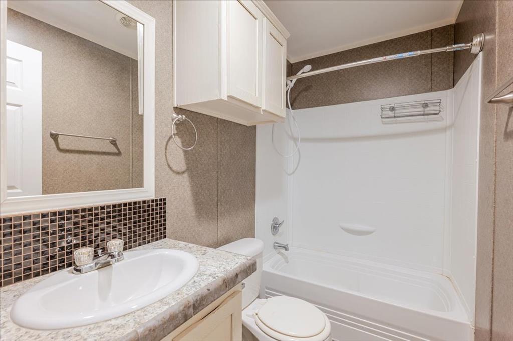 126 Starry Sky Court Springtown, TX 76082 - Photo 17 of 34 Bathroom with vanity, shower / bath combination, and tasteful backsplash