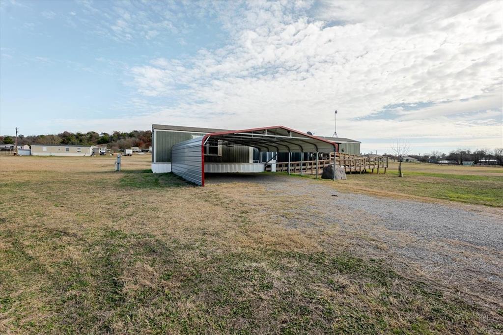 126 Starry Sky Court Springtown, TX 76082 - Photo 27 of 34 carport and driveway