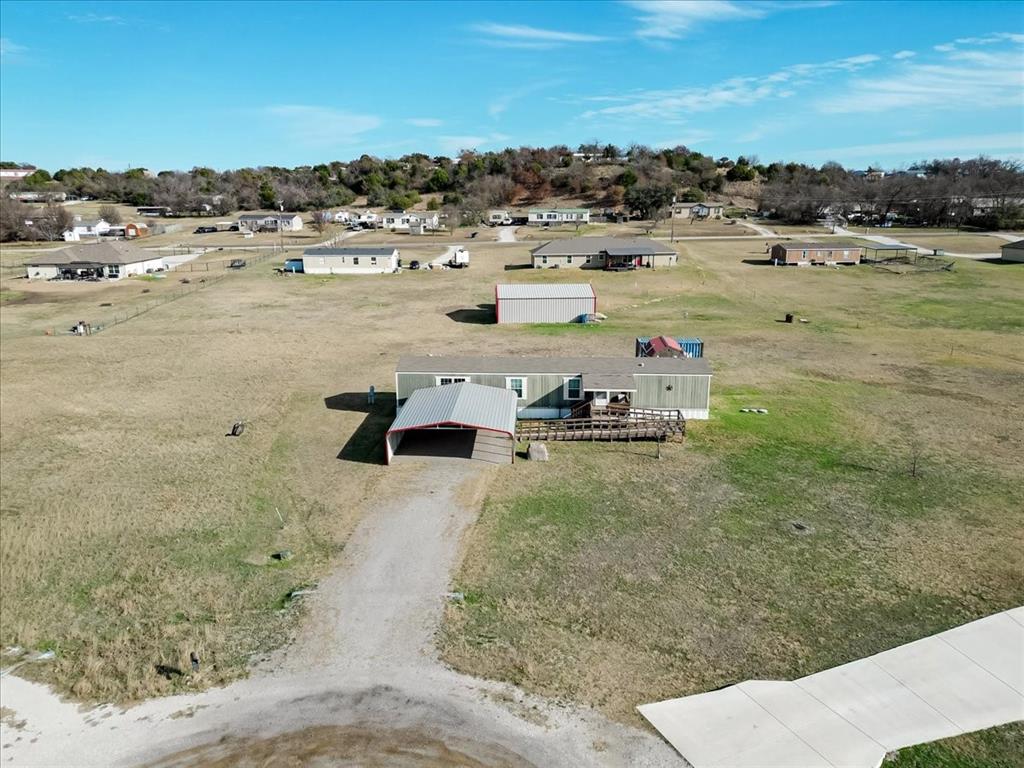 126 Starry Sky Court Springtown, TX 76082 - Photo 33 of 34 View from above of property with a tree filled landscape