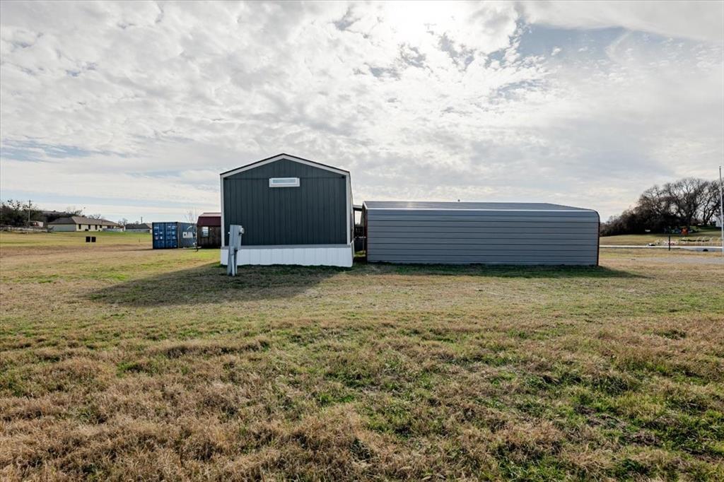 126 Starry Sky Court Springtown, TX 76082 - Photo 34 of 34 View of car port with a yard