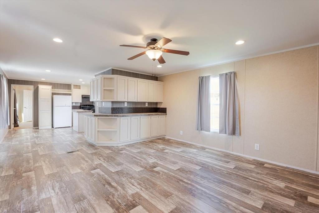 126 Starry Sky Court Springtown, TX 76082 - Photo 4 of 34 Kitchen with open shelves, freestanding refrigerator, light wood finished floors, a ceiling fan, and recessed lighting