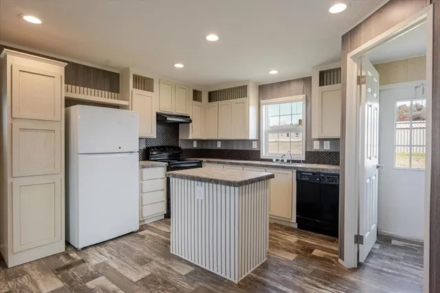 a kitchen with a refrigerator and a sink