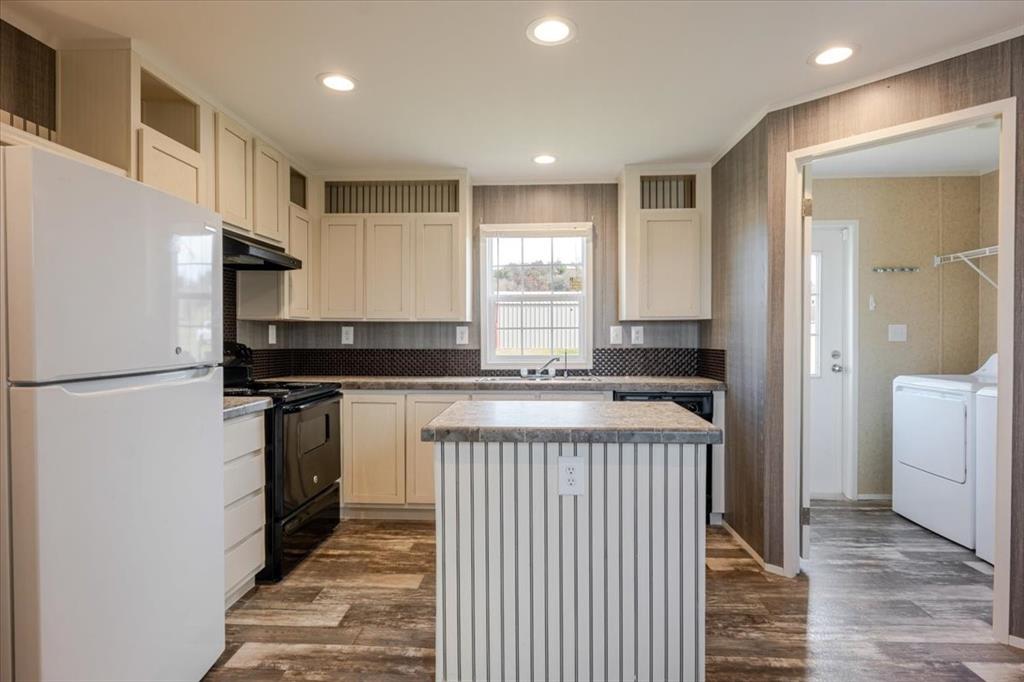 126 Starry Sky Court Springtown, TX 76082 - Photo 8 of 34 Kitchen featuring freestanding refrigerator, black electric range oven, a center island, dark wood finished floors, and recessed lighting
