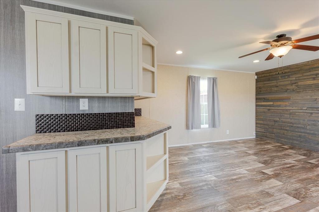 126 Starry Sky Court Springtown, TX 76082 - Photo 9 of 34 Kitchen featuring open shelves, light wood-style floors, wooden walls, a ceiling fan, and recessed lighting