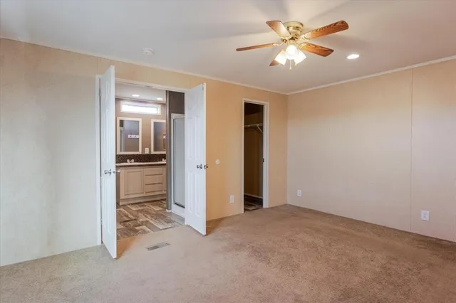 a view of a livingroom with a kitchen space a sink and a refrigerator