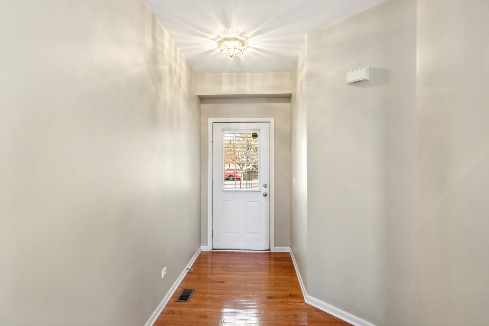 5471 McDonough Road Hoffman Estates, IL 60192 - Photo 3 of 32 a view of a hallway view with a chandelier fan