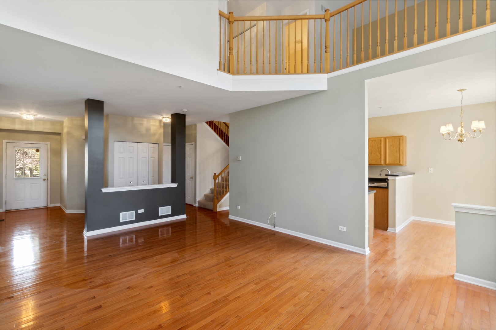 5471 McDonough Road Hoffman Estates, IL 60192 - Photo 5 of 32 a view of an empty room with wooden floor and a window