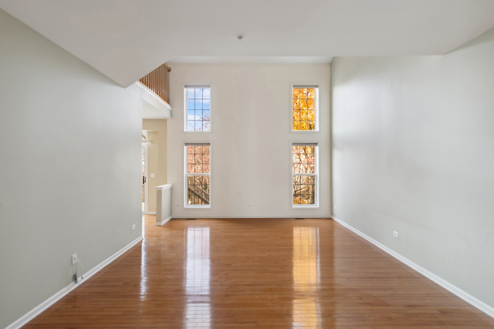 5471 McDonough Road Hoffman Estates, IL 60192 - Photo 7 of 32 a view of an empty room with window and wooden floor