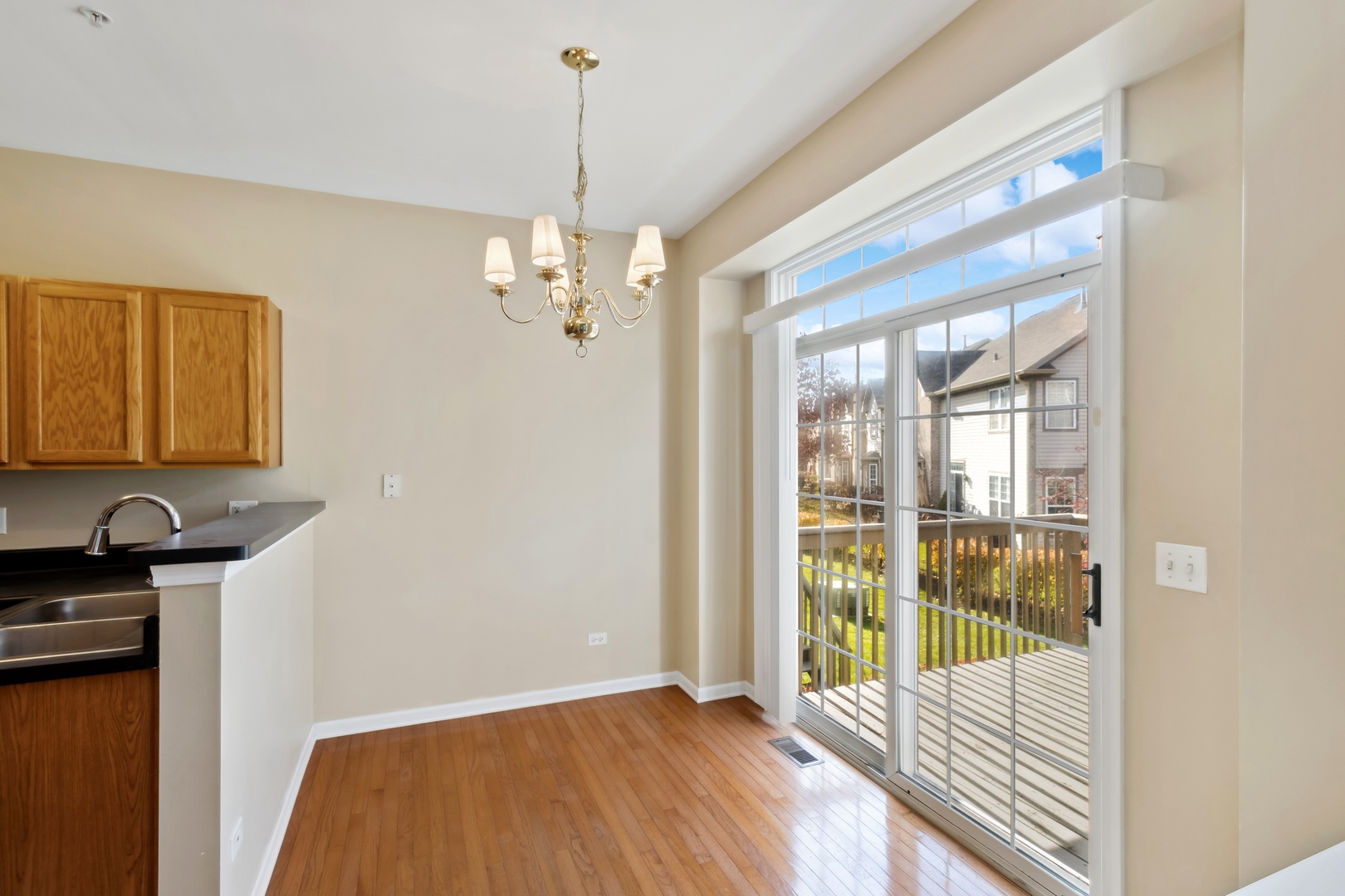 5471 McDonough Road Hoffman Estates, IL 60192 - Photo 8 of 32 a view of a room with wooden floor staircase and a chandelier