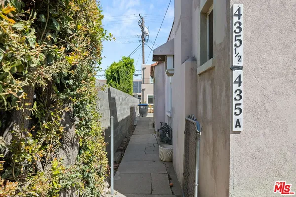 a view of a house with potted plants
