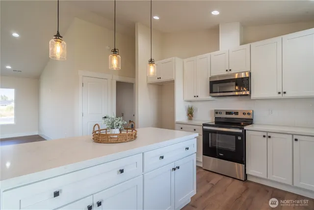 a kitchen with kitchen island white cabinets and white appliances