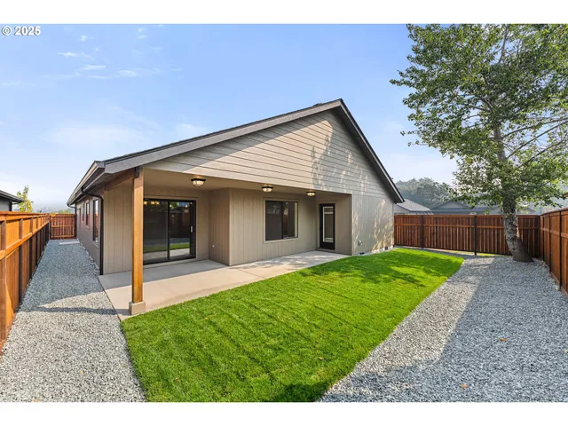a view of a house with a yard and a garden