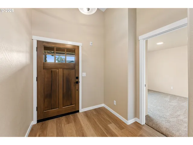 a view of an empty room and wooden floor