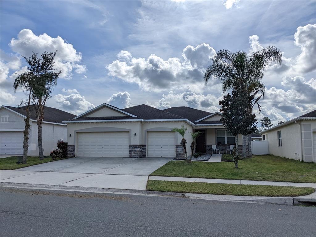 3707 Prescott Loop Lakeland, FL 33810 - Photo 1 of 1 a front view of a house with a garden and a yard