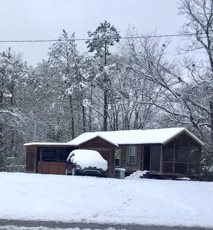 a view of a house with a snow in the yard