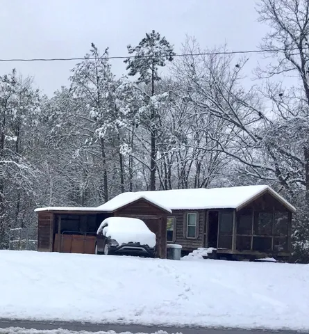 a view of a house with a snow in the yard