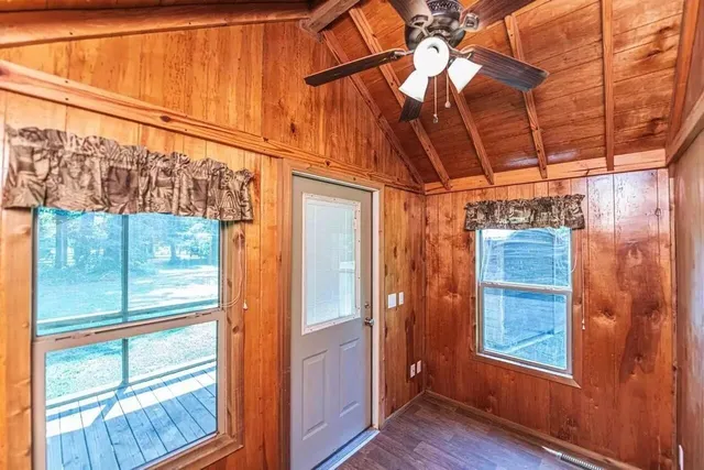 a view of a room with wooden floor and windows
