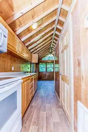 a view of a kitchen with a sink and wooden floor
