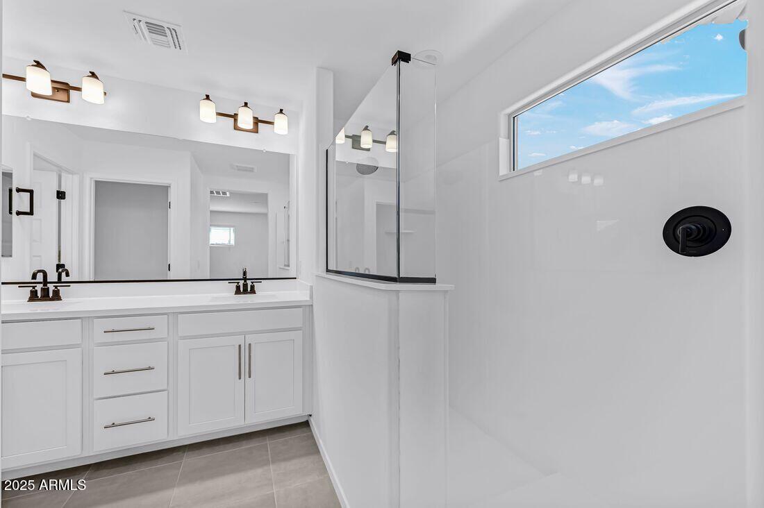 9964 West Piccadilly Road Avondale, AZ 85392 - Photo 23 of 52 a bathroom with a double vanity sink and a mirror