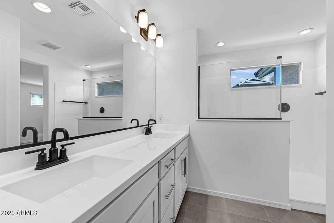 9964 West Piccadilly Road Avondale, AZ 85392 - Photo 26 of 52 a bathroom with a sink and a mirror