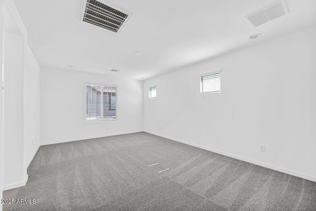9964 West Piccadilly Road Avondale, AZ 85392 - Photo 5 of 52 an empty room with windows