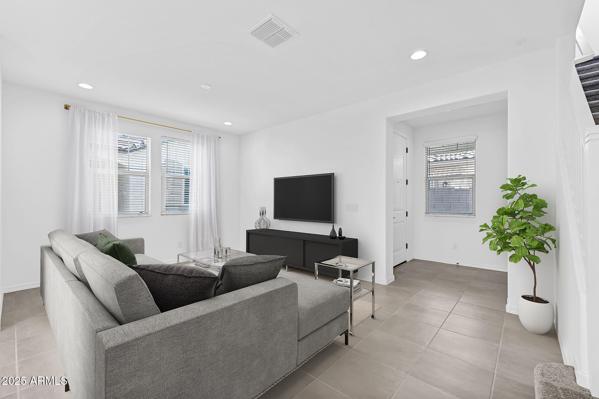9964 West Piccadilly Road Avondale, AZ 85392 - Photo 8 of 52 a living room with furniture and a flat screen tv
