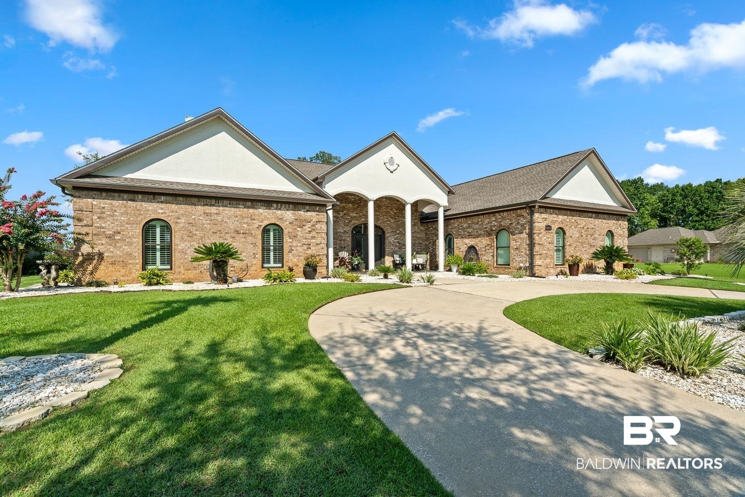 23357 Carnoustie Drive Foley, AL 36535 - Photo 74 of 99 View of front facade with brick siding, a front lawn, and curved driveway