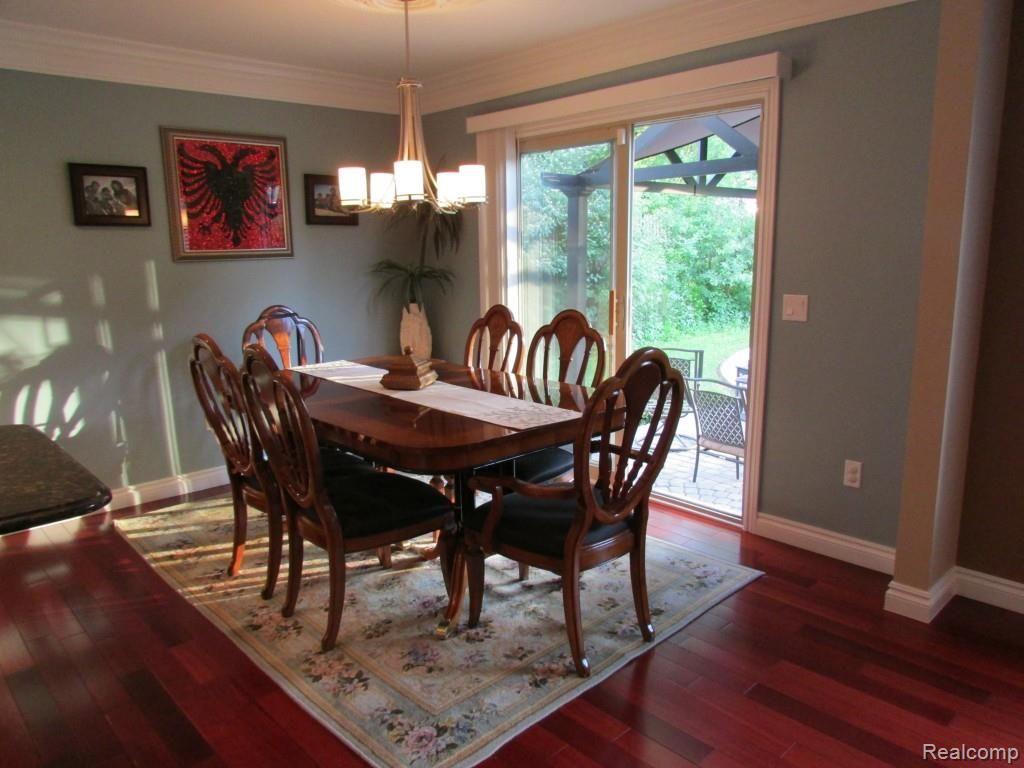 3052 St Clair Drive Rochester, MI 48309 - Photo 8 of 34 Elegant Dining with High-End Lighting and Views to Back Yard