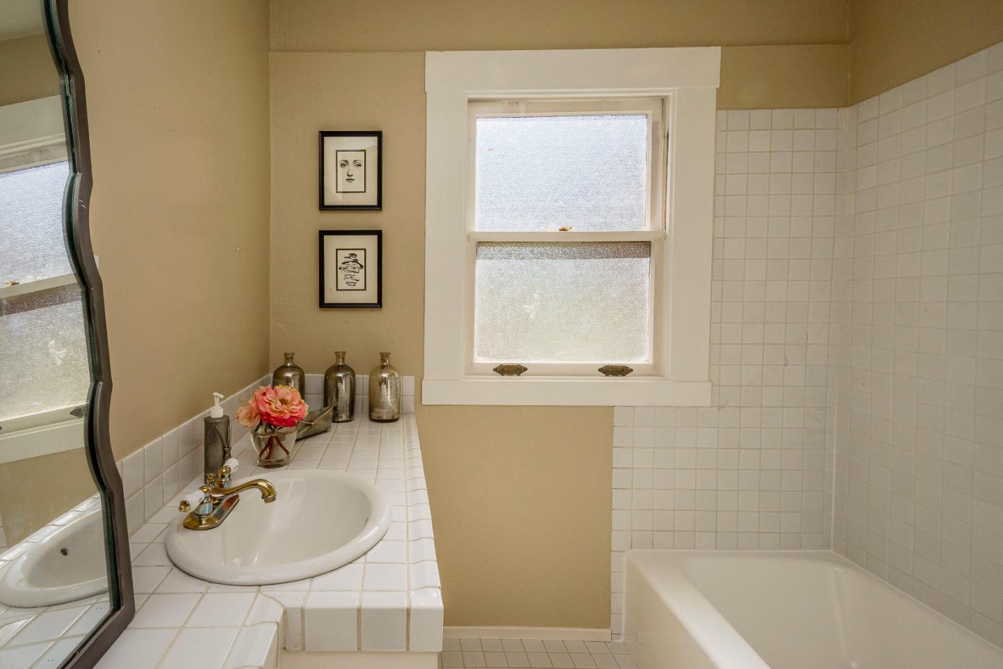 1601 Broadway Burlingame, CA 94010 - Photo 9 of 23 a bathroom with a sink mirror and tub