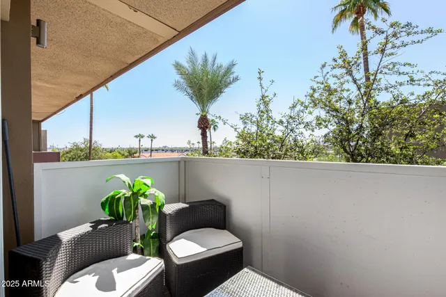 a view of a balcony with chair and table