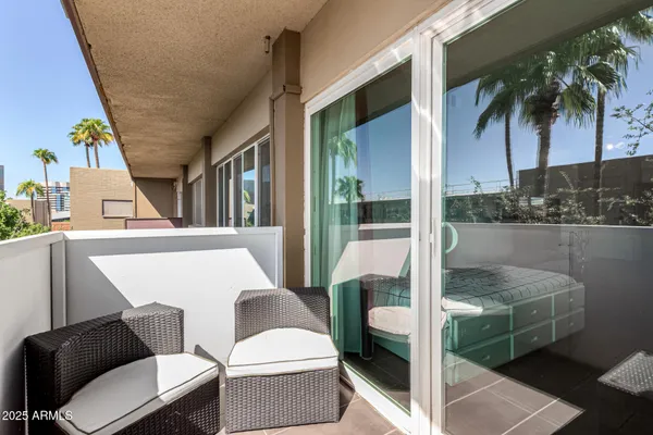 a balcony with table and chairs