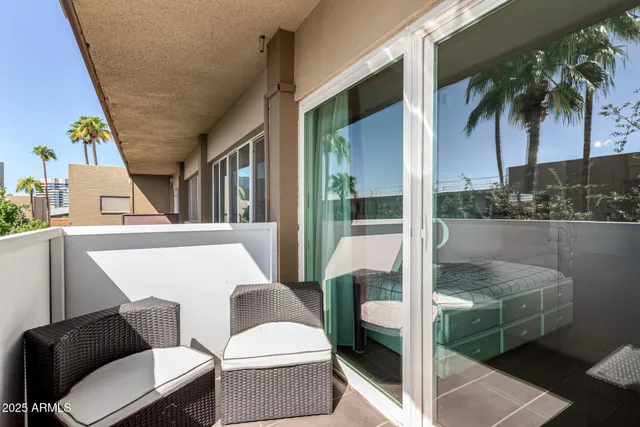 a balcony with table and chairs
