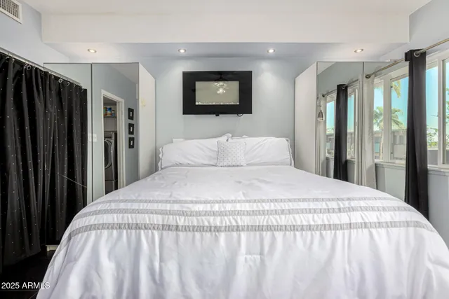 a large white bed in a white room